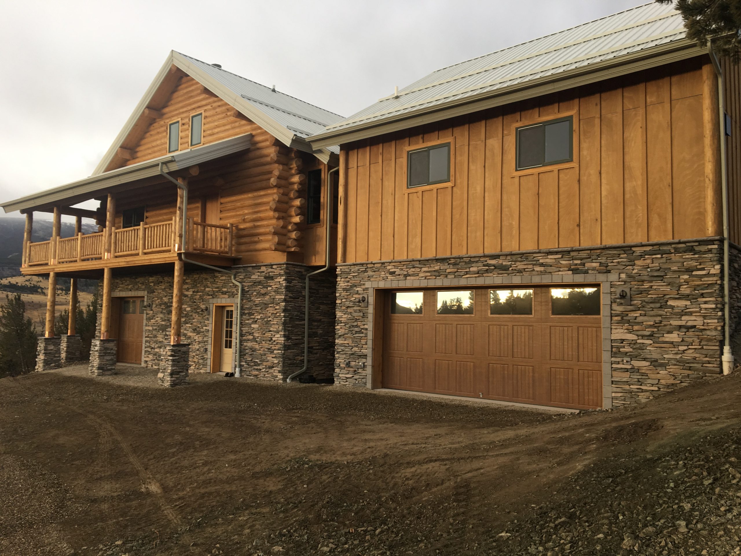 This log home owner has just finished the stone work on the lower level of his home and garage.