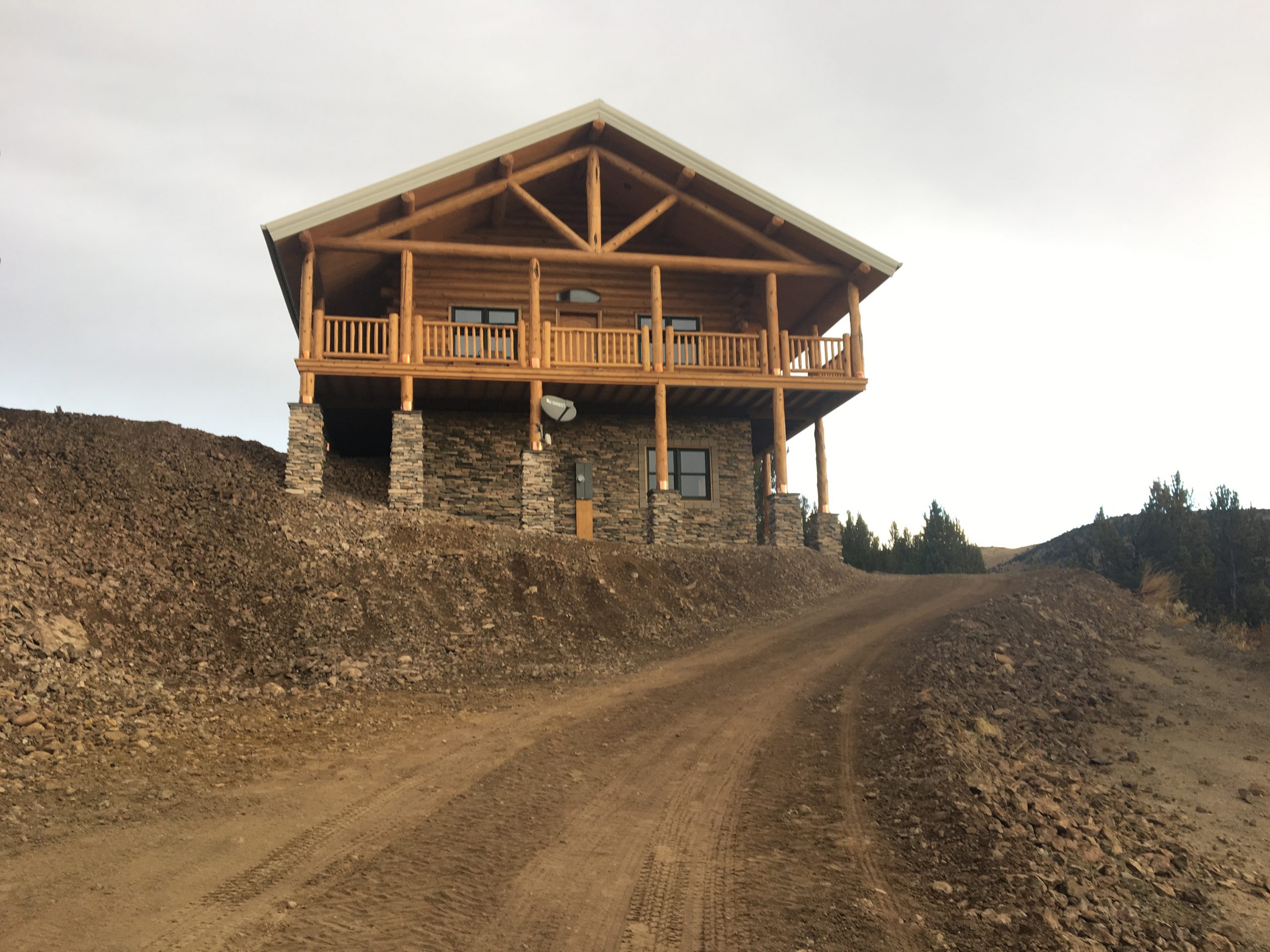 The walk out basement of this handcrafted log home is finished with stone to accent the logs.