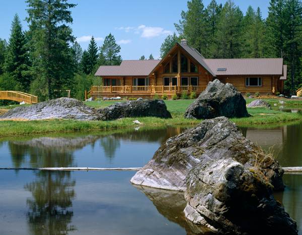 a log cabin by a lake