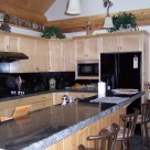 Custom kitchen design with dark granite countertops.