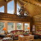 Interior living room of log home with glass wall.