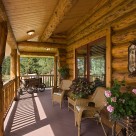 Covered porch of handcrafted log home