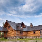 Handcrafted log home with gable dormer viewed from exterior