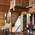 Log staircase leading to open loft with log railings.