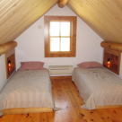 Sleeping loft in small log cabin