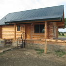 Exterior of log cabin with covered porch