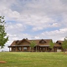 Beautiful ranch style log home with dormers and attached log garage.