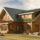 Custom handcrafted log home exterior photo on sunny day.