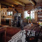 Interior of rustic log cabin with western art and antique wood cook stove