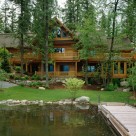 Luxury log home on walk out basement viewed from dock on Swan Lake mt.