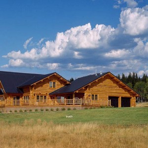 Exterior of handcrafted log home with attached garage