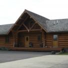 Log home entry with log truss