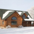 Exterior of handcrafted log home in winter