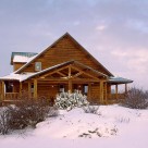 Exterior of custom log home with attached carport and wrap around porches on snowy winter day.