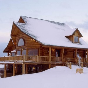 Exterior of handcrafted log home in winter