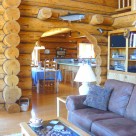 Interior of log home with archway between living room and kitchen