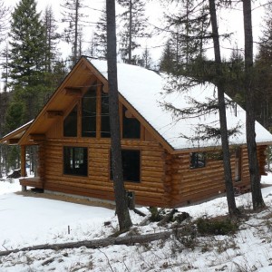 Exterior of lag cabin in winter