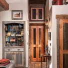 Antique wood doors and barnwood shelves in custom log home.