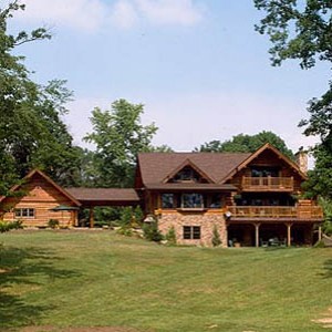 Exterior of log home with breezway to log garage
