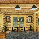 Rendering of log home dining room with french doors viewing forest beyond.