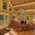 Living room with river rock fireplace in handcrafted log cabin.