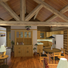 Interior rendering of handcrafted log home kitchen and dining rooms with log truss supporting roof purlins and pine ceiling.