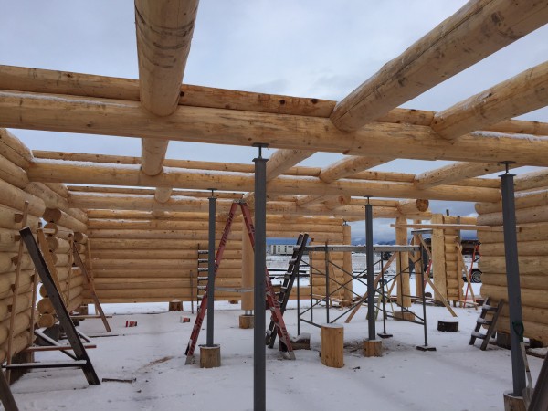 This construction shot shows a oft support system with stringer logs, infills, and log joists.