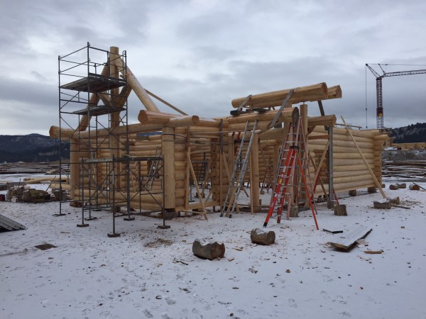 The custom log truss is set and the log roof support systems starts next.