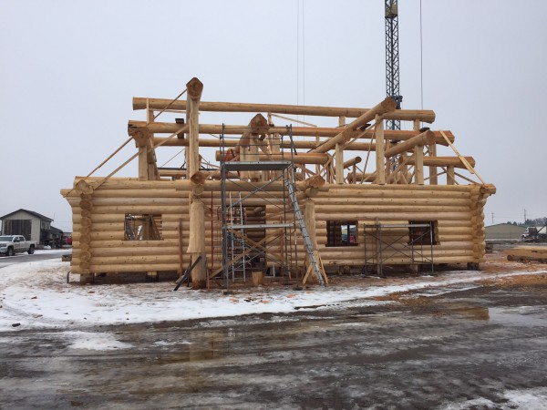 A complex log roof support system is finalized and the handcrafted log shell is ready to go.
