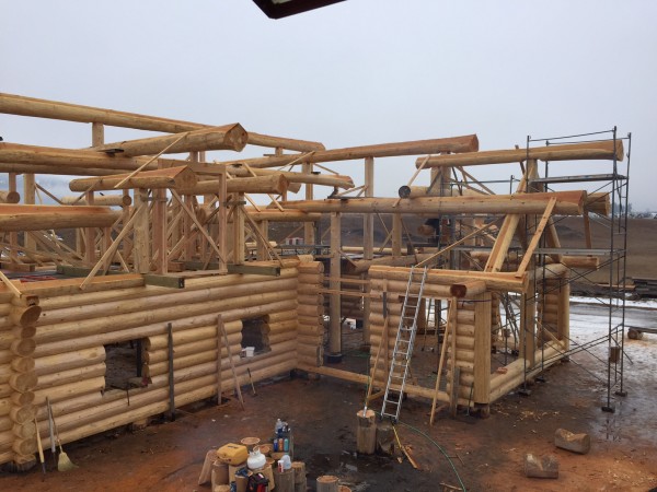 With scaffolding and ladders the log roof support system is completed for this handcrafted log package.
