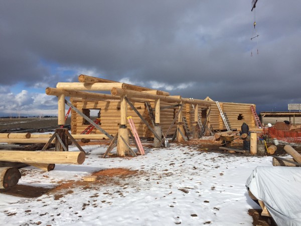 Handcrafted log walls show the progress on this log home.