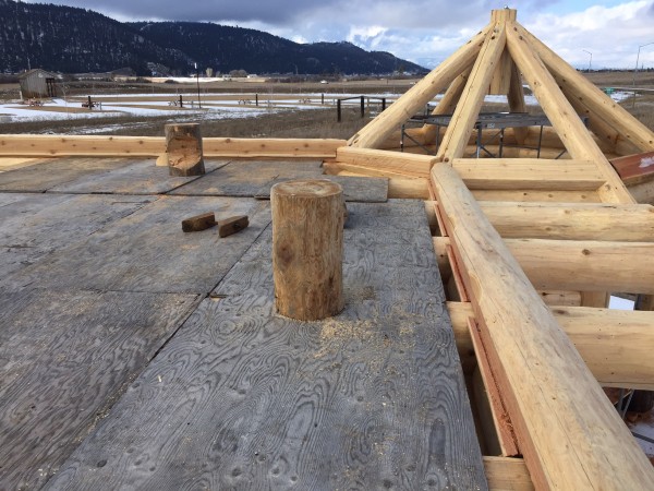 A close up construction shot of the slotting provided for the loft floor in this custom log home package.
