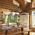 Log home dining room with custom picnic table and white cabinet