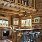 Log home kitchen with breakfast bar and blue bar stools