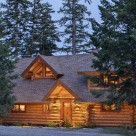 Twilight photo of handcrafted log home entry