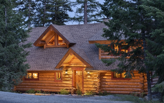 Evening picture of a handcrafted log home.