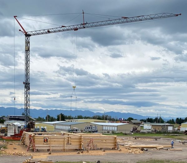 A tower crane looms over the custom log package. A key piece of equipment when building with full length logs.